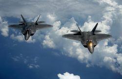 Side by side F-22's midflight